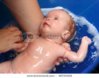 stock-photo-newborn-baby-bath-in-blue-bathtub-by-mother-46733452.jpg