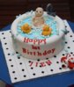 Cute first birthday cake with baby in tub and rubber duckies.JPG